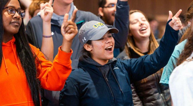 Students do the HSU cheer in chapel.